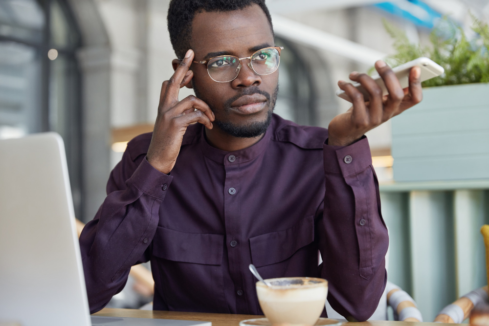 Anxious client checking smartphone representing stress and information gap